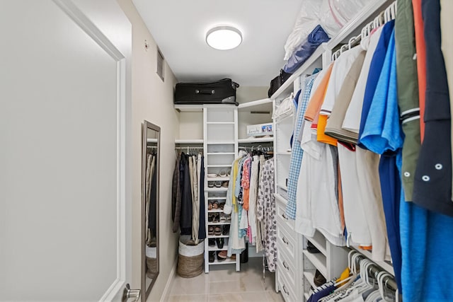 walk in closet featuring light tile patterned flooring