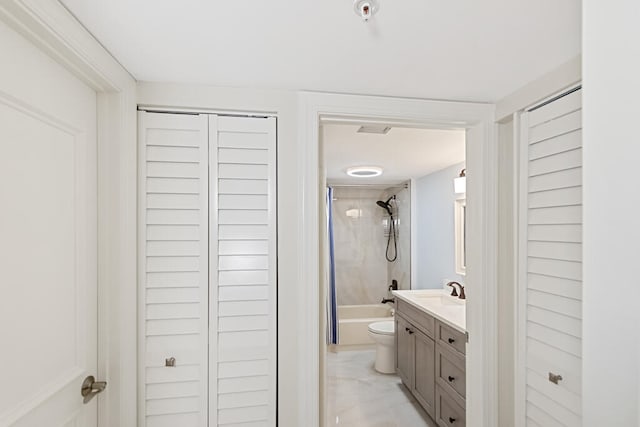 full bathroom with vanity, toilet, and tiled shower / bath combo