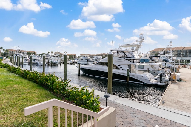 view of dock with a water view and a yard