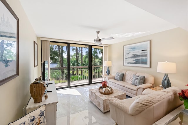 living room featuring expansive windows and ceiling fan