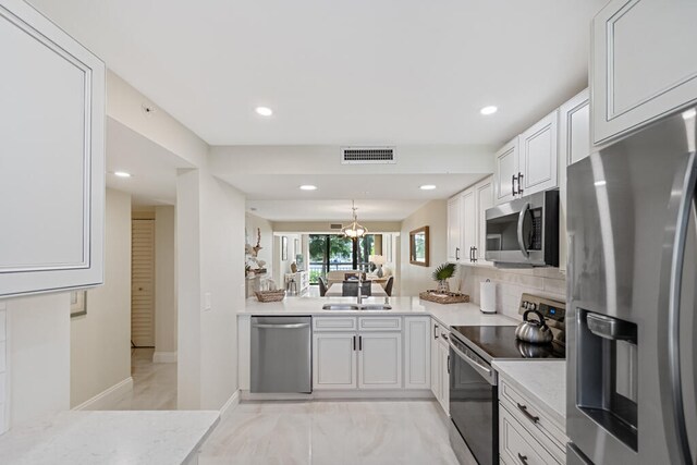 kitchen with white cabinetry, appliances with stainless steel finishes, and sink