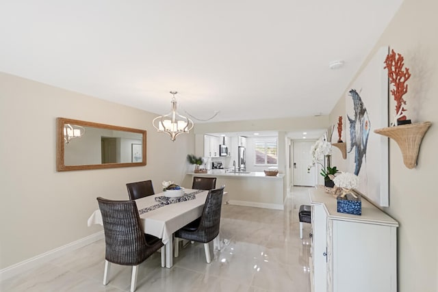 dining room featuring sink and a notable chandelier