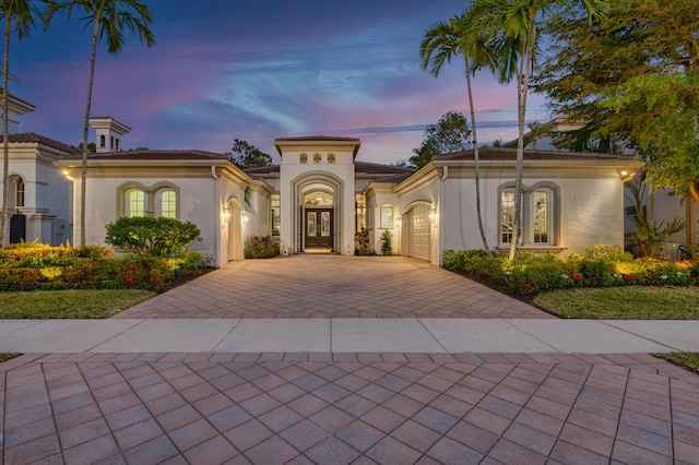 mediterranean / spanish-style house with french doors and a garage