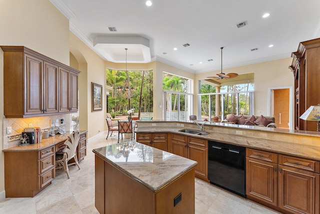 kitchen with light stone counters, ceiling fan with notable chandelier, sink, black dishwasher, and a kitchen island