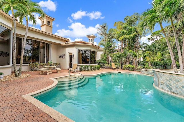 view of swimming pool featuring a patio area