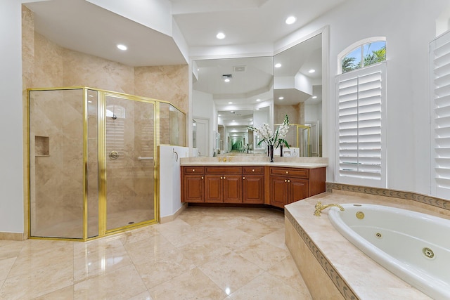 bathroom with vanity and independent shower and bath