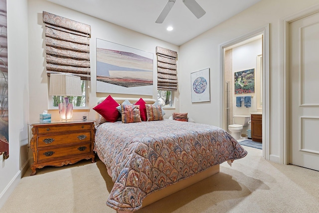 bedroom featuring connected bathroom, ceiling fan, light colored carpet, and multiple windows