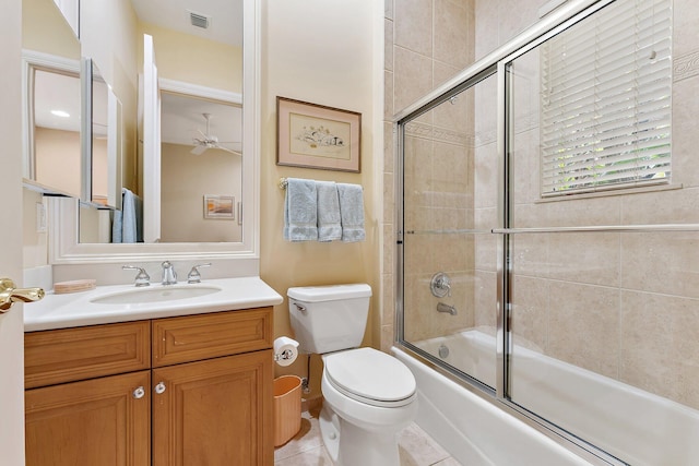 full bathroom featuring shower / bath combination with glass door, tile patterned floors, vanity, and toilet