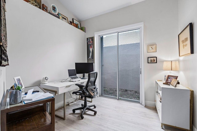 home office with light hardwood / wood-style floors