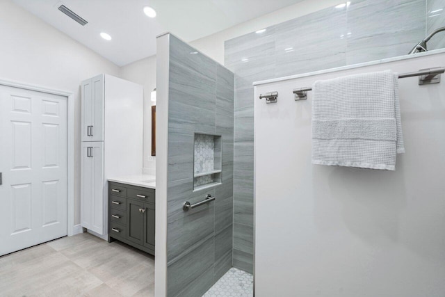 bathroom with a shower and vanity