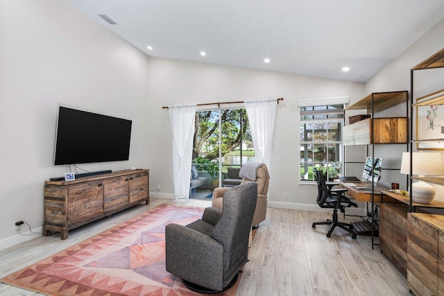 office featuring light hardwood / wood-style floors and high vaulted ceiling