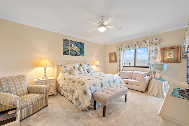 carpeted bedroom featuring ceiling fan and crown molding