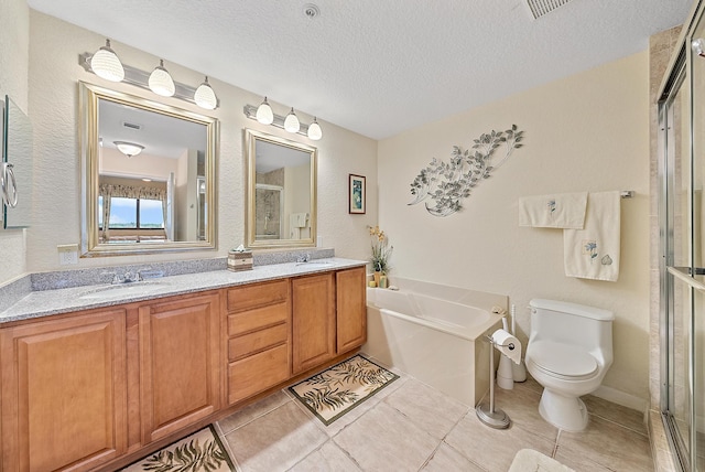 full bathroom with vanity, tile patterned flooring, separate shower and tub, toilet, and a textured ceiling