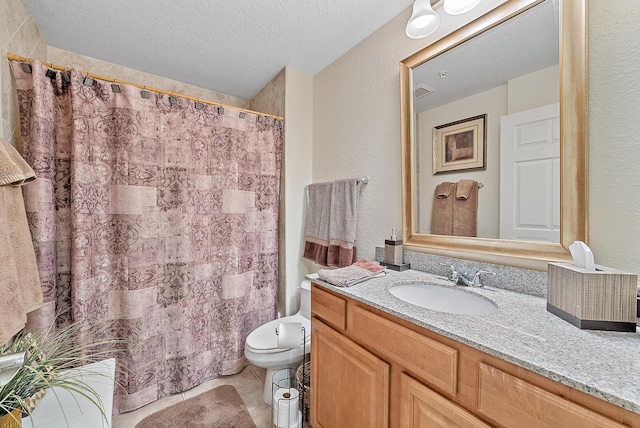 bathroom featuring a textured ceiling, vanity, and tile patterned floors