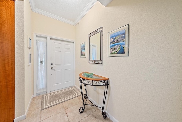 tiled foyer entrance featuring crown molding