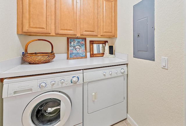 laundry area with cabinets, electric panel, and washer and clothes dryer