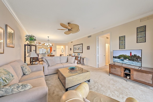 carpeted living room with ceiling fan with notable chandelier and ornamental molding