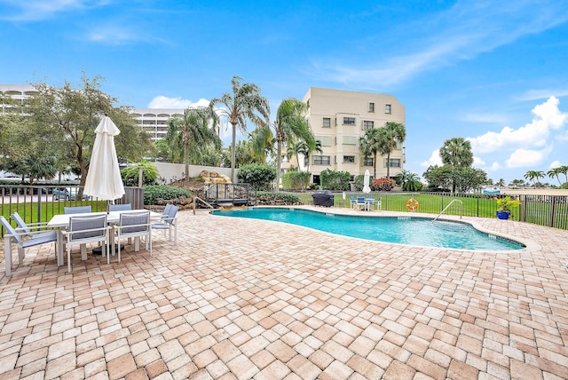 view of swimming pool featuring a yard and a patio area