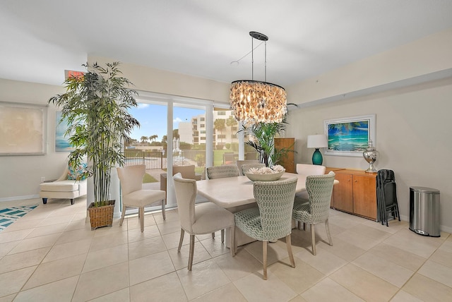 dining room featuring light tile patterned flooring and an inviting chandelier