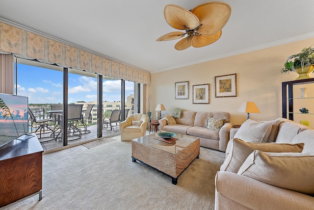 living room featuring ceiling fan, light colored carpet, and ornamental molding