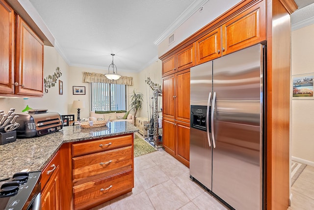 kitchen featuring appliances with stainless steel finishes, dark stone counters, crown molding, pendant lighting, and light tile patterned floors