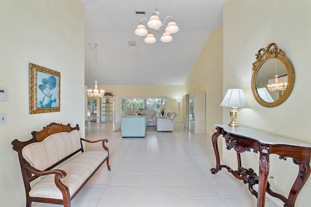 interior space featuring light tile patterned floors, high vaulted ceiling, and a notable chandelier