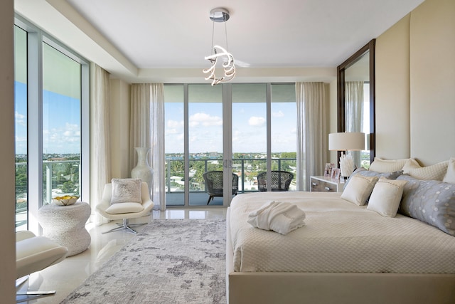 bedroom with access to outside, a wall of windows, and an inviting chandelier