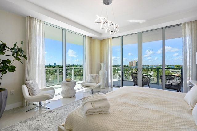 tiled bedroom featuring access to exterior, multiple windows, and a chandelier