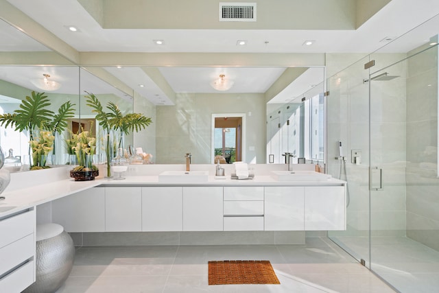 bathroom with walk in shower, tile patterned flooring, and vanity