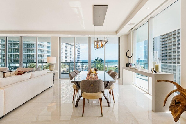 dining area with floor to ceiling windows and a notable chandelier