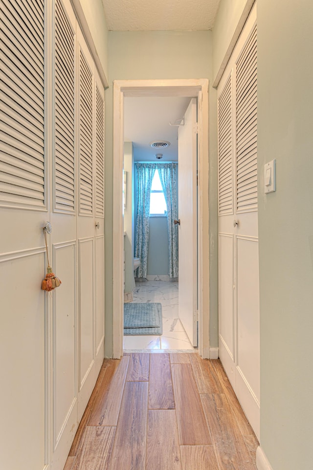 corridor featuring light wood-type flooring