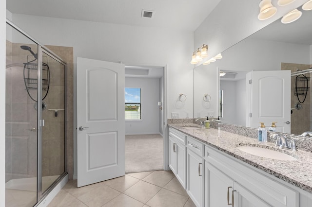 bathroom featuring vanity, tile patterned floors, and a shower with door