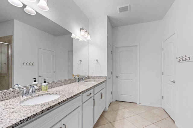 bathroom with vanity, tile patterned floors, and an enclosed shower