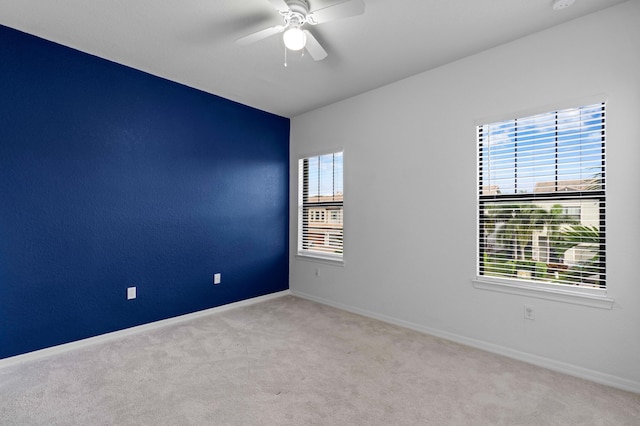 carpeted empty room with ceiling fan