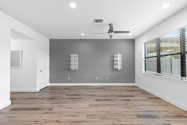 spare room with light hardwood / wood-style flooring and ceiling fan