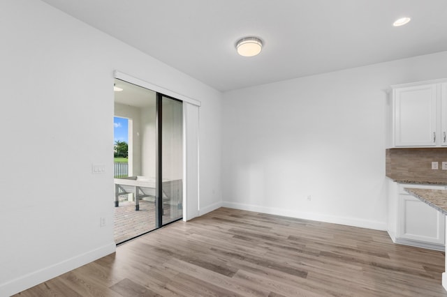 unfurnished dining area with light hardwood / wood-style flooring