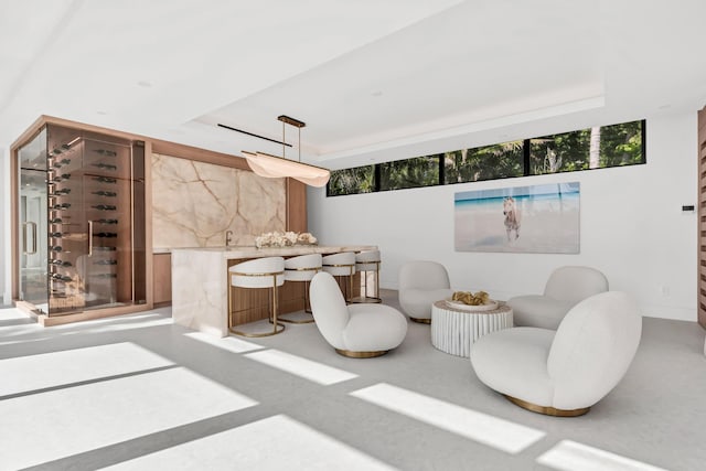 5 S Beach Rd, Jupiter Island, FL 33455 - living area with a tray ceiling, wet bar, and healthy amount of natural light