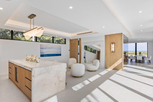 tiled living room with a raised ceiling