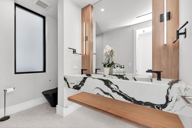 bathroom featuring vanity, tile patterned flooring, and toilet