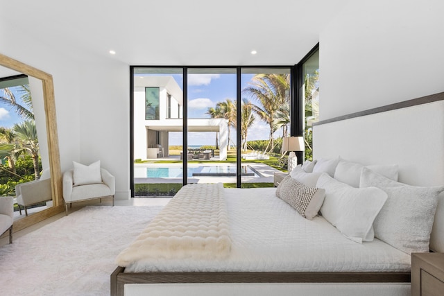 bedroom featuring expansive windows and access to exterior