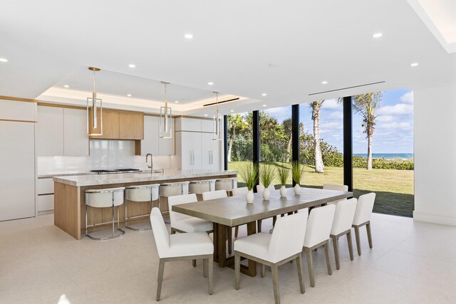 5 S Beach Rd, Jupiter Island, FL 33455 - dining room featuring recessed lighting, expansive windows, and a tray ceiling