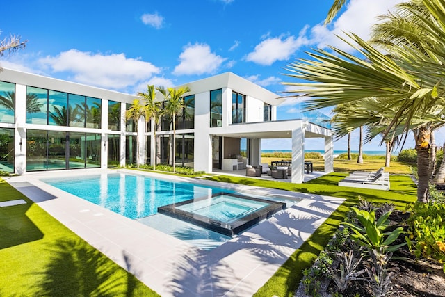 view of swimming pool with an in ground hot tub