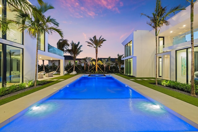 view of pool at dusk