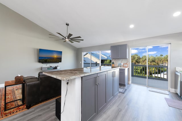 1441 NE 14th Ct Unit 4, Jensen Beach, FL 34957 - kitchen with gray cabinetry, open floor plan, light wood-type flooring, ceiling fan, and lofted ceiling