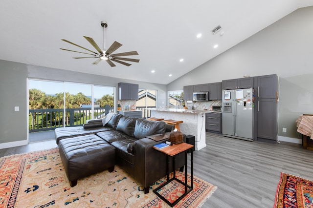 1441 NE 14th Ct Unit 4, Jensen Beach, FL 34957 - living area with a ceiling fan, high vaulted ceiling, recessed lighting, light wood finished floors, and baseboards