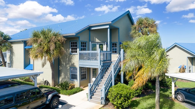 coastal inspired home with a carport and a balcony