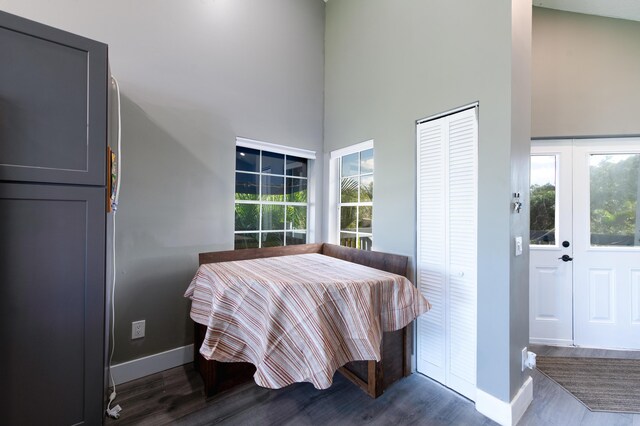 1441 NE 14th Ct Unit 4, Jensen Beach, FL 34957 - dining space featuring baseboards, wood finished floors, and a towering ceiling