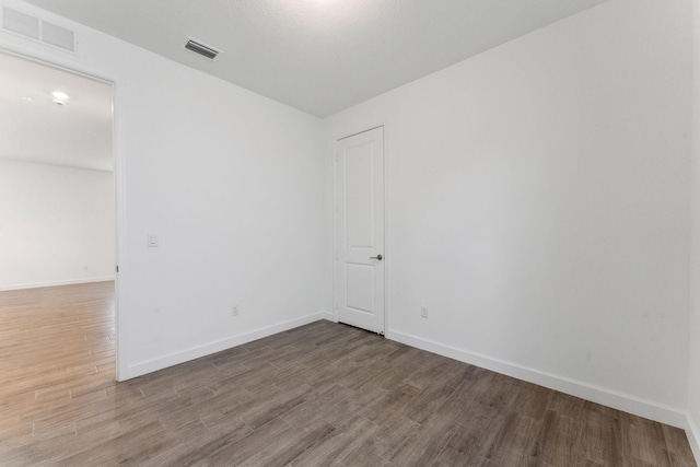 spare room featuring hardwood / wood-style flooring