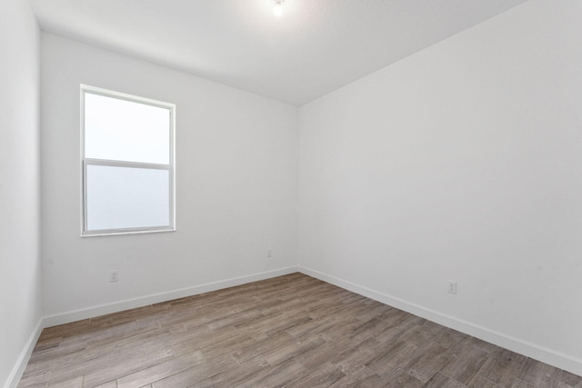 spare room featuring light wood-type flooring and a wealth of natural light