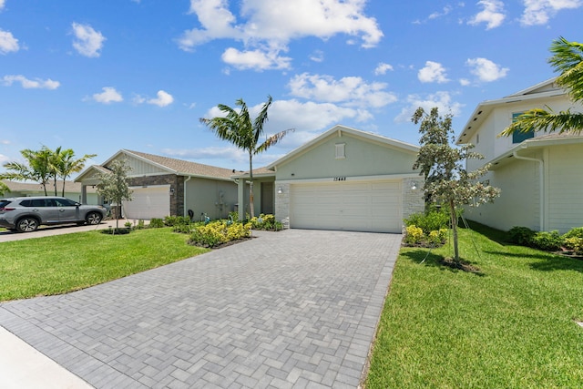 single story home with a garage and a front lawn